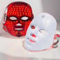 LumiGlow 7-color LED face mask with red light on, next to the white mask