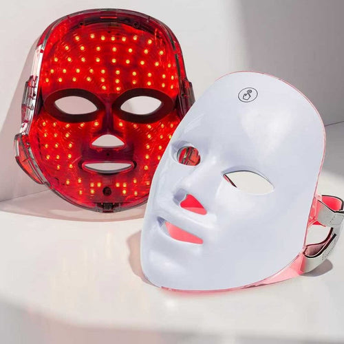 LumiGlow 7-color LED face mask with red light on, next to the white mask