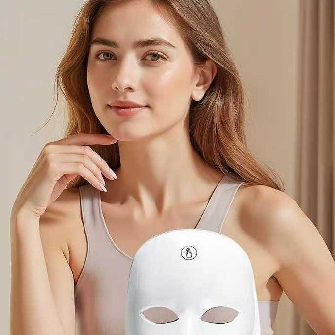 Woman with clear skin holding the white LumiGlow LED mask